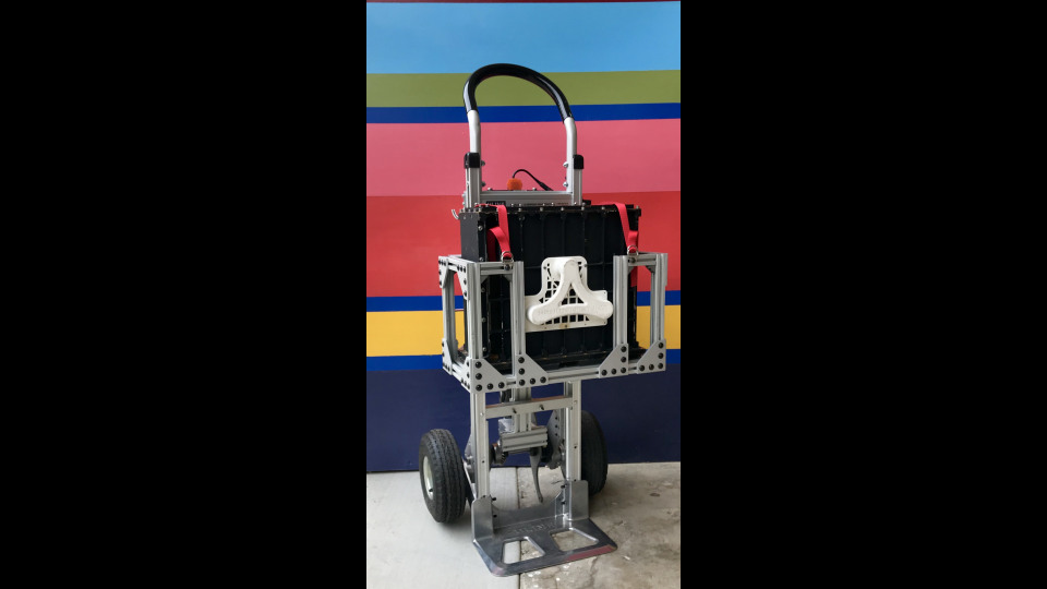 Figure 1: The payload is the black package. The system was built on top of an off-the-shelf dolly.